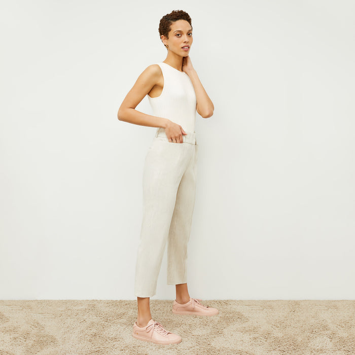 Side image of a woman standing wearing the Chester Pant Slubbed Stretch Linen in Natural | Lead