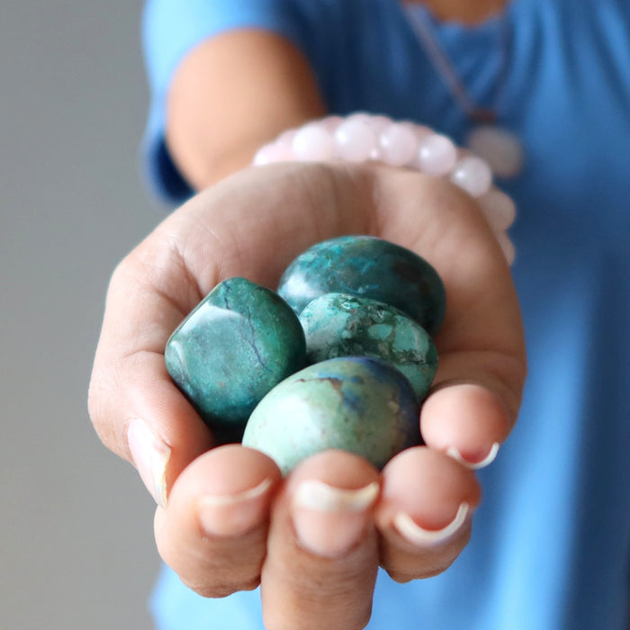hand holding Chrysocolla Tumbled Stones