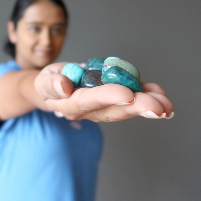 hand holding Chrysocolla Tumbled Stones