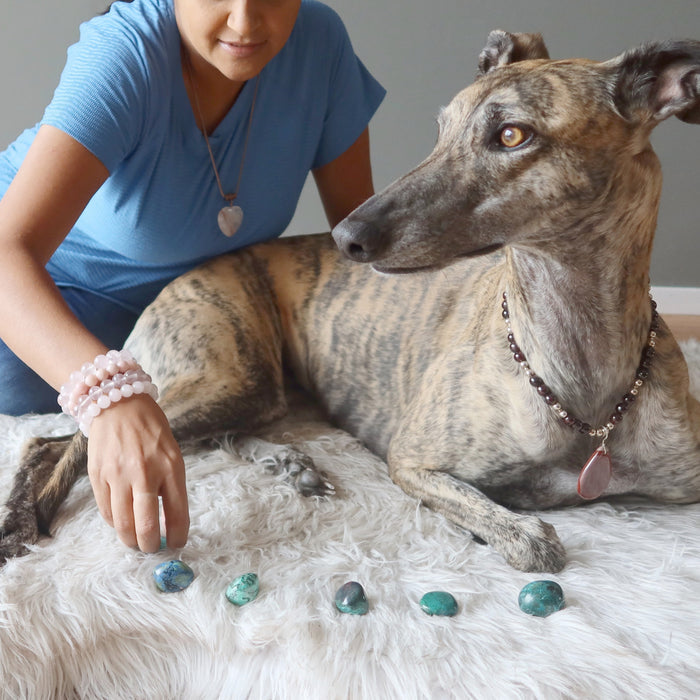 Rose of Satin Crystals laying next to Chrysocolla Tumbled Stones