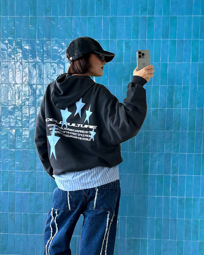 COSMOS ARC HOODIE INDIA INK - washed black star print hoodie, street style shot - Cold Culture