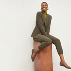 Front image of a woman standing wearing the Delaney Jogger—OrigamiTech in Olive