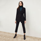 Front image of a woman standing wearing the Finley Legging—Ribbed Jardigan Knit in Black
