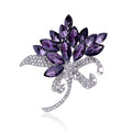 Purple leaf-shaped brooch with clear crystals on a white background
