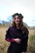 Celtic shawl in maroon and black with silver Trinity brooch styled as an elegant layered wrap