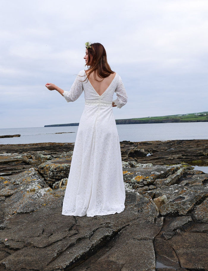 Back view of Celtic Fusion ivory lace wedding dress with deep V back, fitted waist and full-length flowing skirt